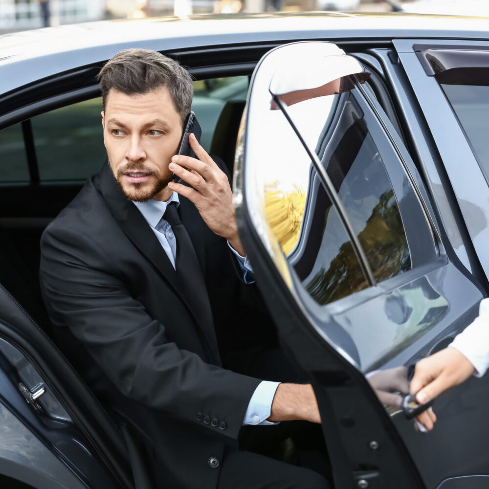 Businessman getting out of luxury car